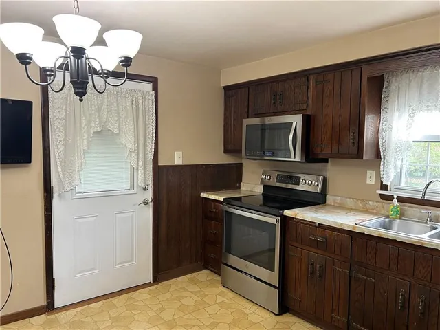 a kitchen with a sink stainless steel appliances and cabinets