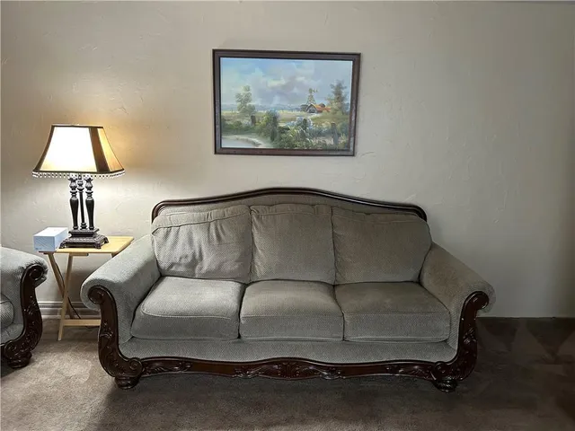 a living room with a couch and a lamp