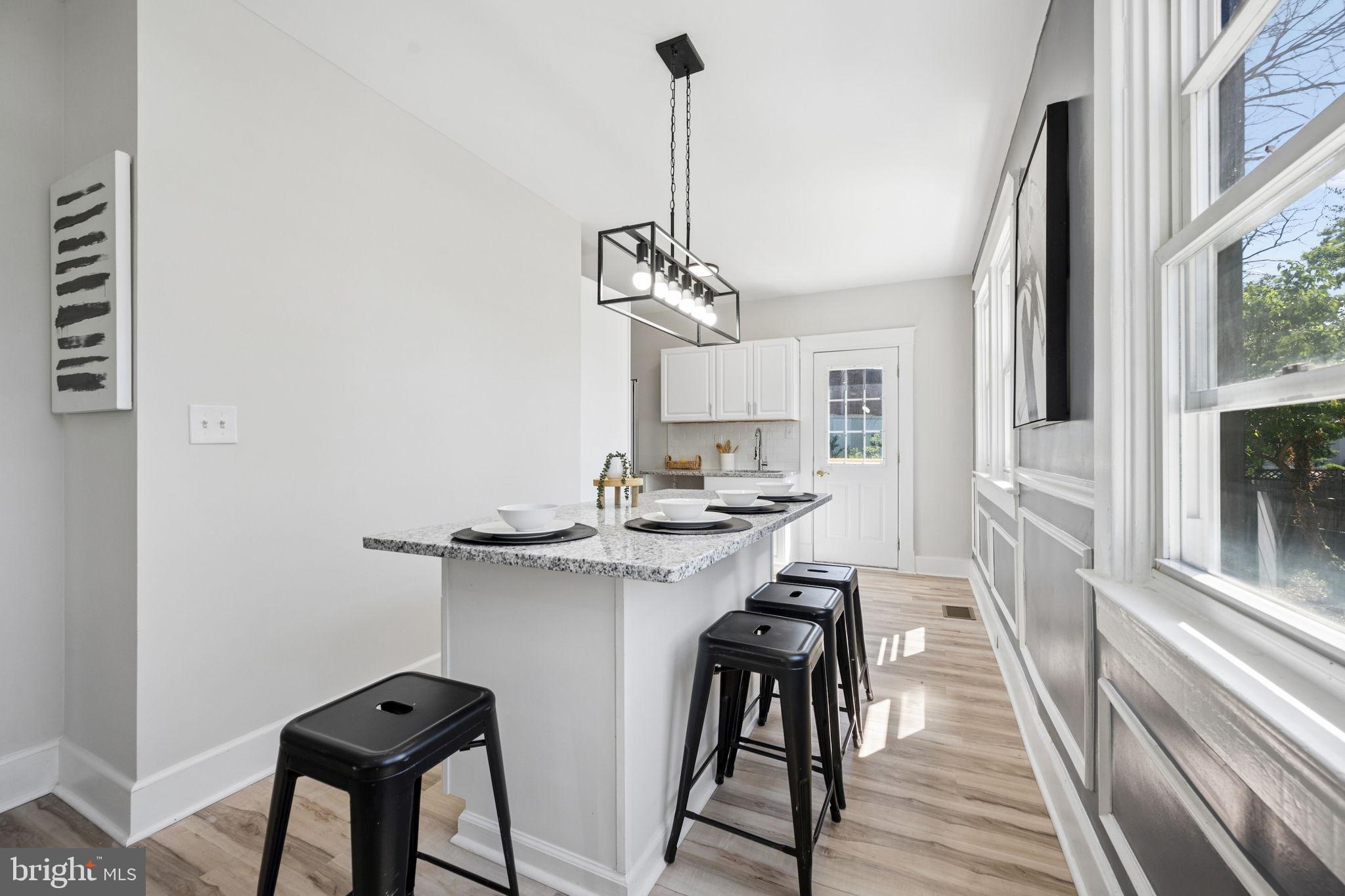 517 Valcour Road Baltimore, MD 21228 - Photo 21 of 47 a kitchen with a table and chairs in it