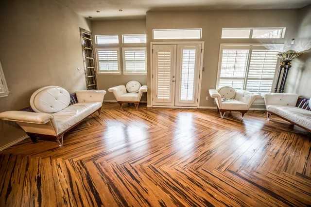 a living room with furniture and wooden floor