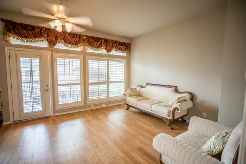 a spacious bedroom with a bed and a large window