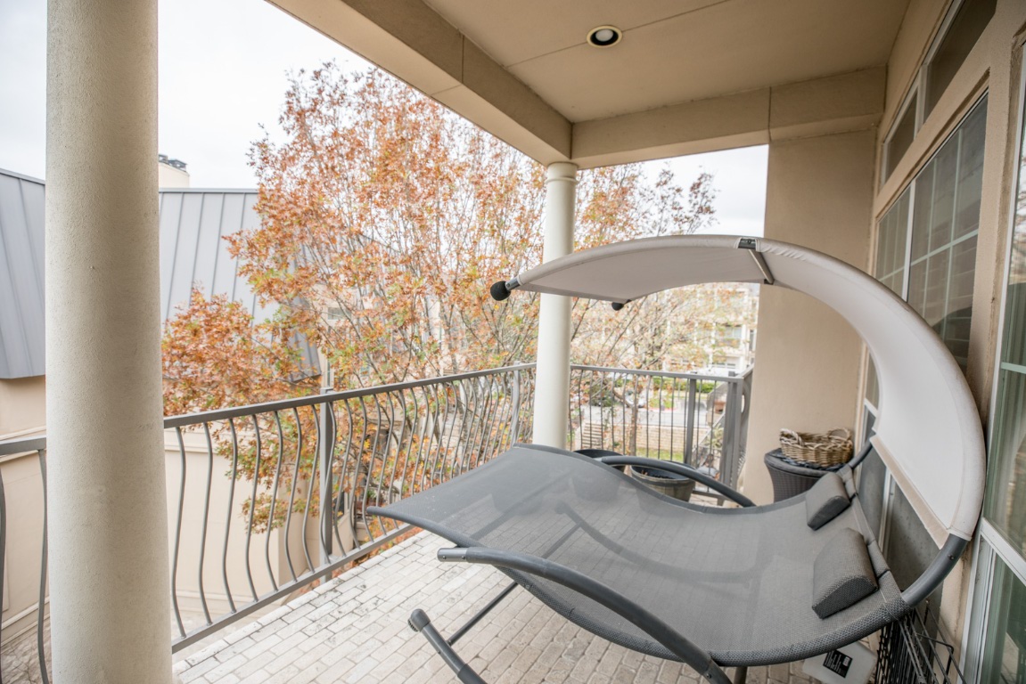 2918 Ranch Road 620 North, Unit 270 Austin, TX 78734 - Photo 24 of 34 a view of a balcony with furniture and wooden floor