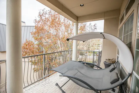 a view of a balcony with furniture and wooden floor