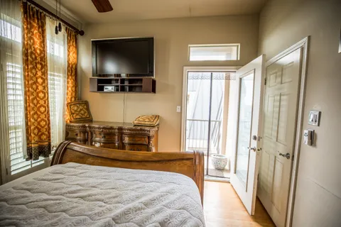 a bedroom with a bed and a flat screen tv