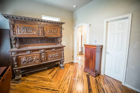 a view of a room with wooden floor