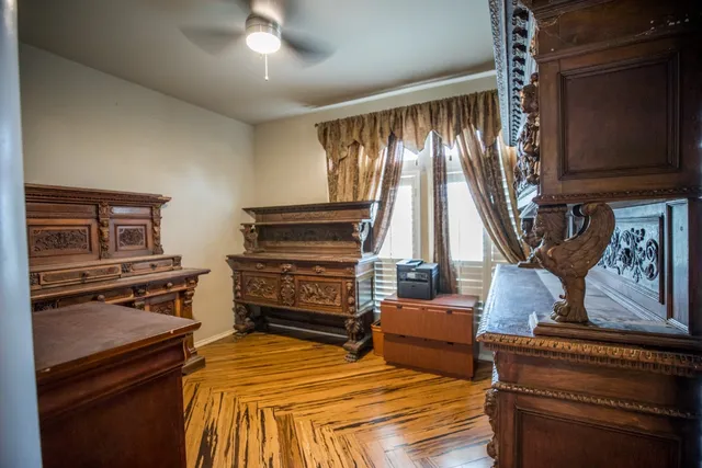 a bedroom with furniture and a flat screen tv