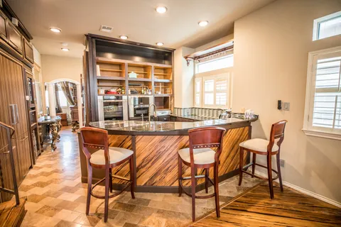 a dining room with granite countertop a table and chairs