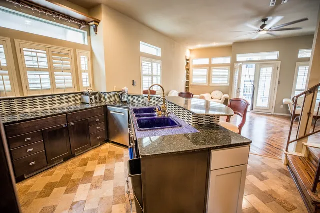 a large kitchen with kitchen island granite countertop a large window
