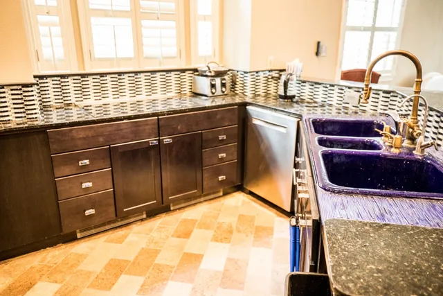 a kitchen with a sink and a large window