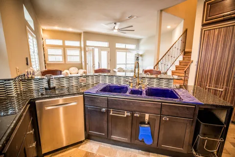 a kitchen with stainless steel appliances granite countertop a sink stove and cabinets