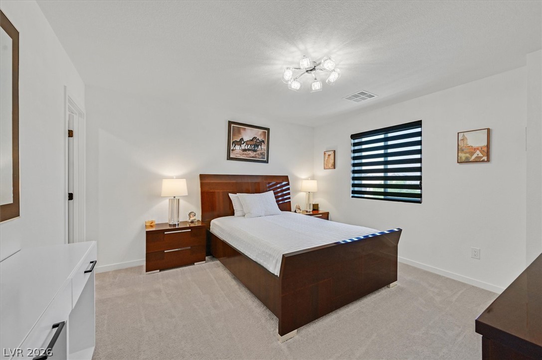 2933 Little Current Road North Las Vegas, NV 89086 - Photo 24 of 35 Step into a serene primary bedroom featuring plush carpeting and soft overhead lighting.