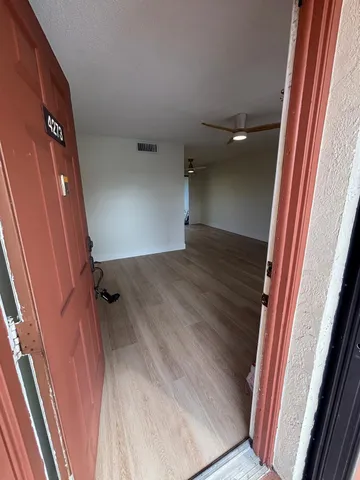 a view of a room with wooden floor and stairs