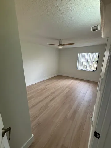 an empty room that has a window in it