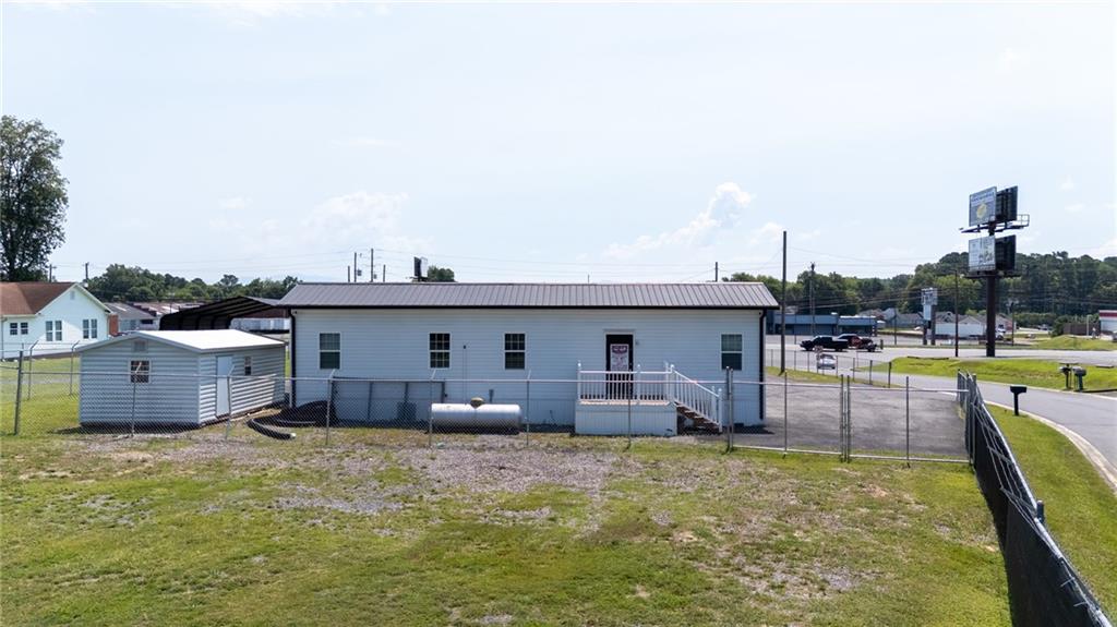 2213 Cleveland Highway Dalton, GA 30721 - Photo 16 of 41 a view of a swimming pool with a chair and tables