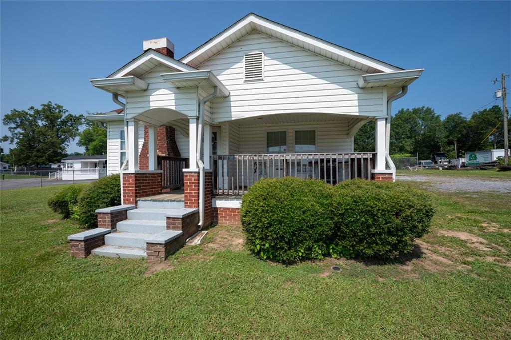 2213 Cleveland Highway Dalton, GA 30721 - Photo 19 of 41 a front view of a house with a yard table and chairs