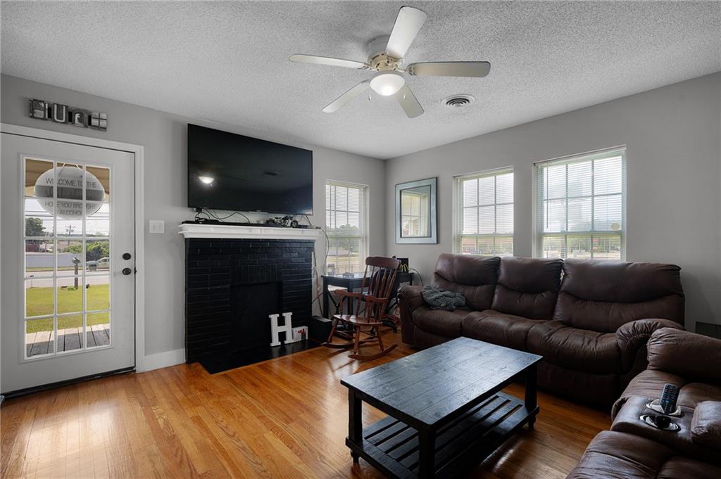 2213 Cleveland Highway Dalton, GA 30721 - Photo 25 of 41 a living room with furniture a flat screen tv and a fireplace