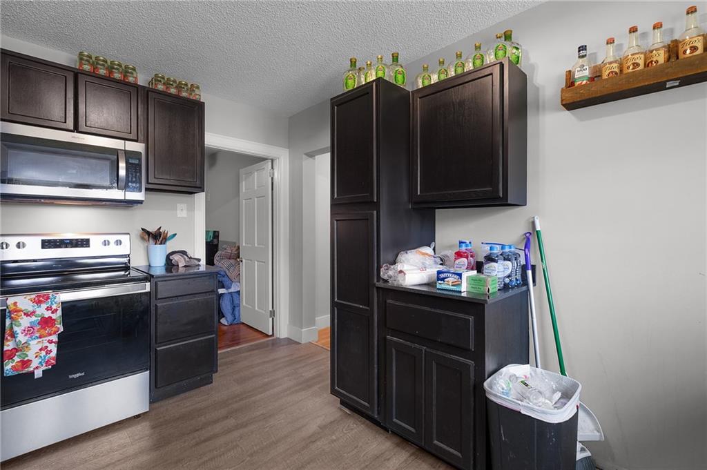 2213 Cleveland Highway Dalton, GA 30721 - Photo 30 of 41 a kitchen with stainless steel appliances granite countertop a refrigerator and a stove