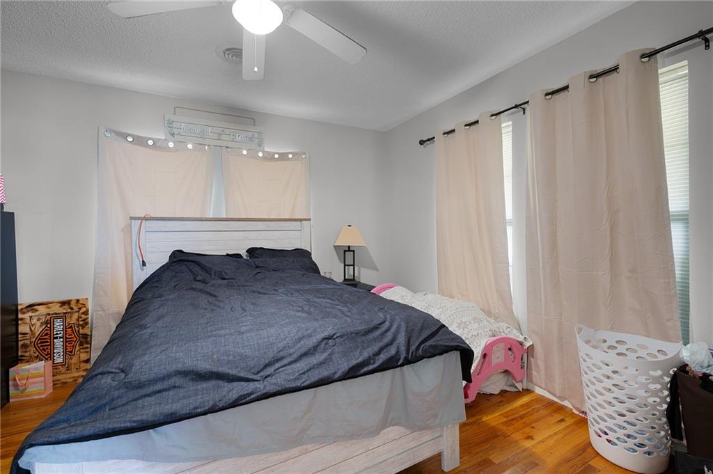 2213 Cleveland Highway Dalton, GA 30721 - Photo 33 of 41 a bedroom with a bed and a chandelier