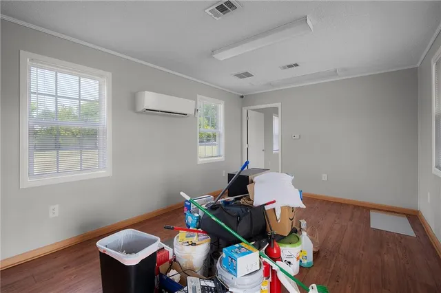 a view of a workspace with furniture and a window
