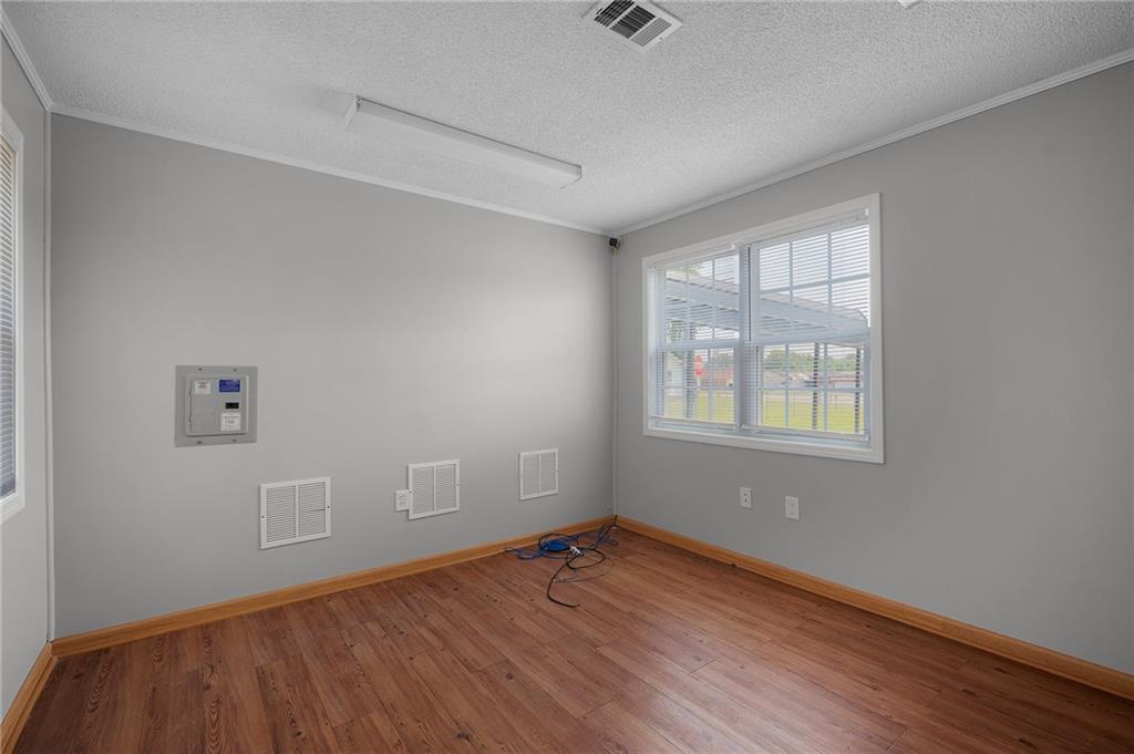 2213 Cleveland Highway Dalton, GA 30721 - Photo 36 of 41 an empty room with wooden floor and windows
