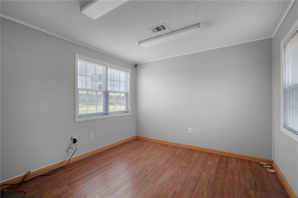 2213 Cleveland Highway Dalton, GA 30721 - Photo 37 of 41 an empty room with wooden floor and windows
