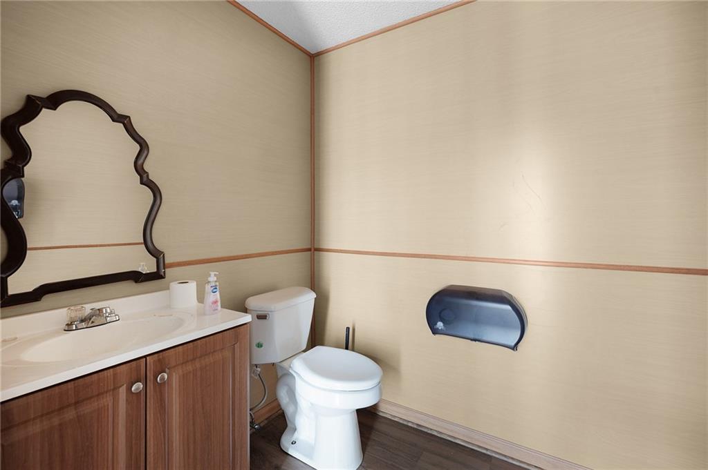 2213 Cleveland Highway Dalton, GA 30721 - Photo 38 of 41 a bathroom with a sink a toilet and a mirror