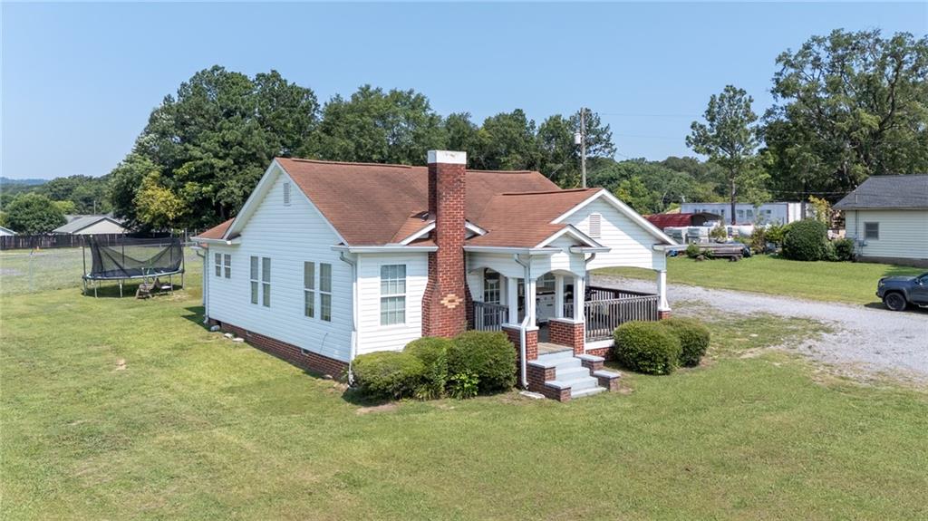 2213 Cleveland Highway Dalton, GA 30721 - Photo 8 of 41 a view of a house with a yard and potted plants
