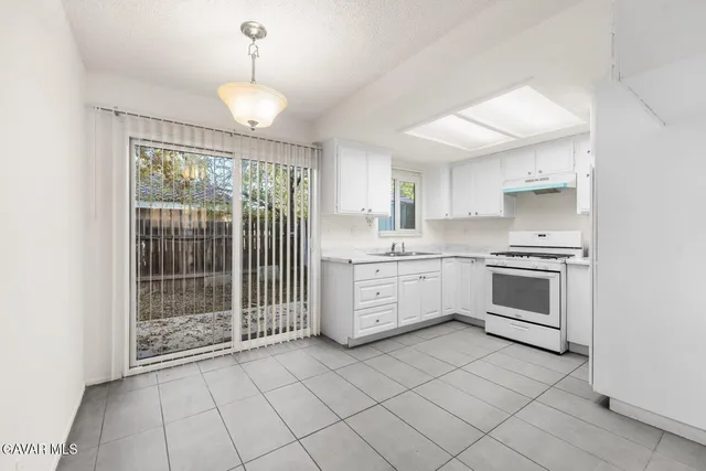 a kitchen with a stove oven and sink