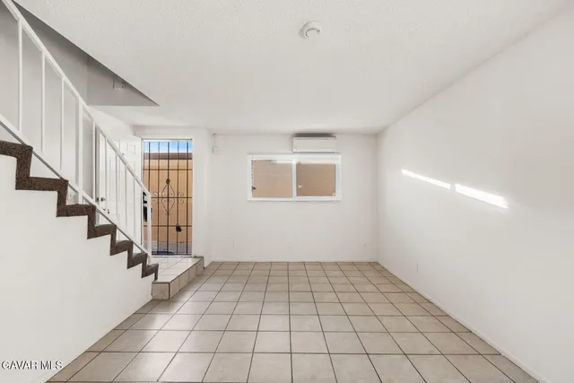 a view of an empty room with stairs