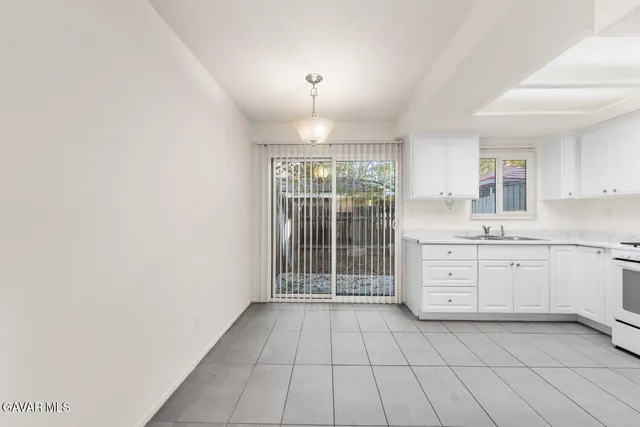 a kitchen with a sink window and cabinets
