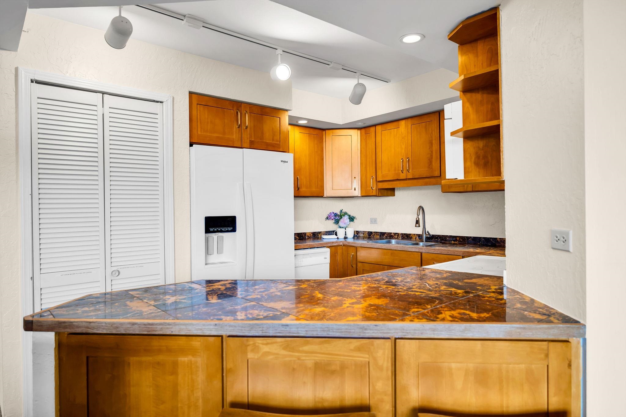 3445 Lower Honoapiilani Road, Unit 516 Lahaina, HI 96761 - Photo 20 of 49 a kitchen with stainless steel appliances granite countertop a sink and a window