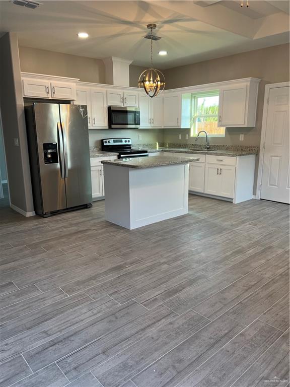 2108 Redbud Lane Weslaco, TX 78596 - Photo 2 of 9 a large kitchen with stainless steel appliances granite countertop a stove a sink dishwasher and a refrigerator