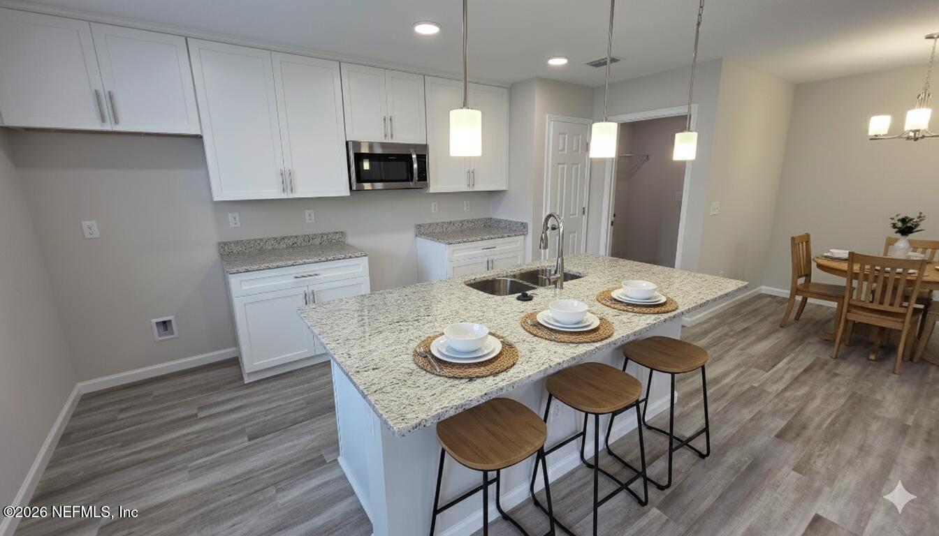 1076 Cahoon Road South Jacksonville, FL 32221 - Photo 3 of 7 a view of a dining room with furniture and wooden floor