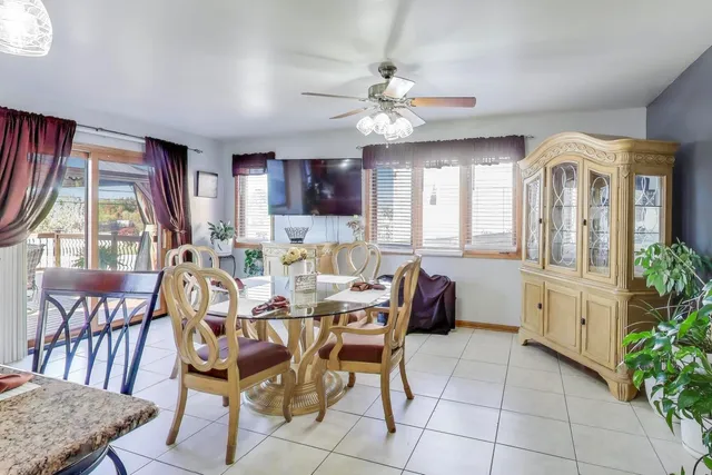 a living room with furniture a fireplace and a chandelier