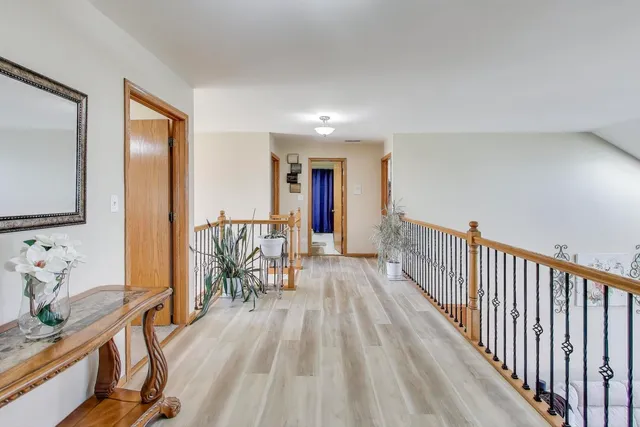 a bedroom with a bed couch and a chandelier