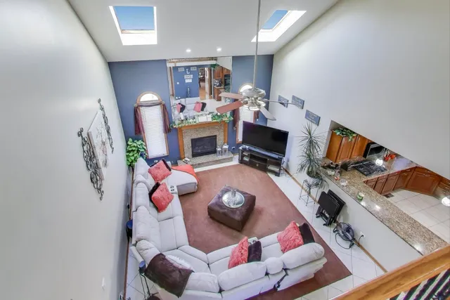 a bedroom with a bed couch and a chandelier