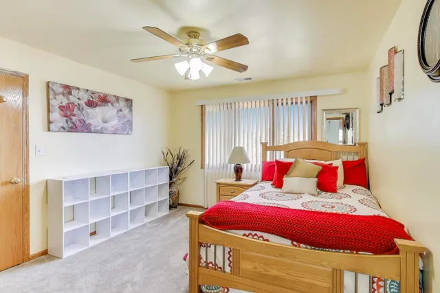 a bedroom with a bed and a chandelier
