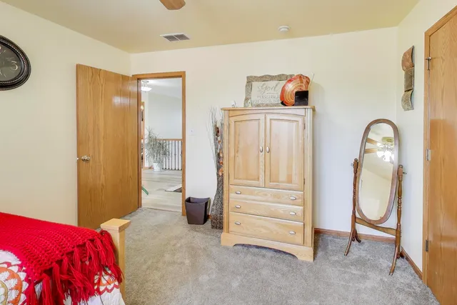 a bedroom with a large bed and a window