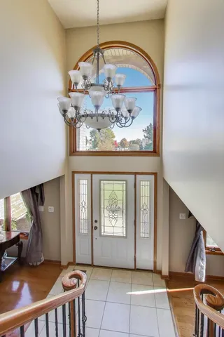 a living room with furniture and a lamp on table with wooden floor
