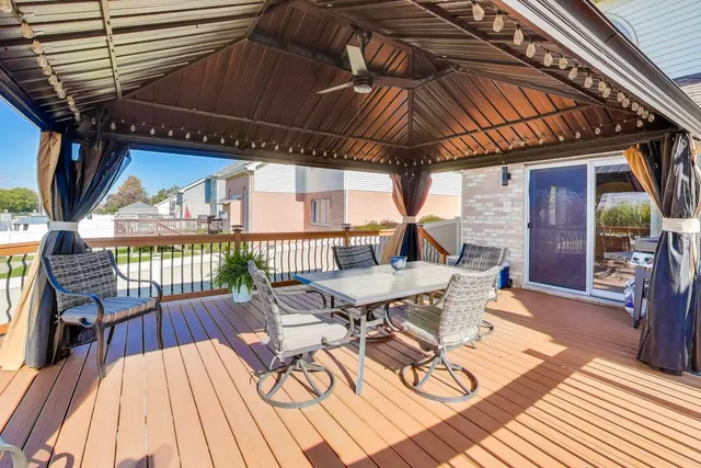 a view of a big house with a big yard and large trees
