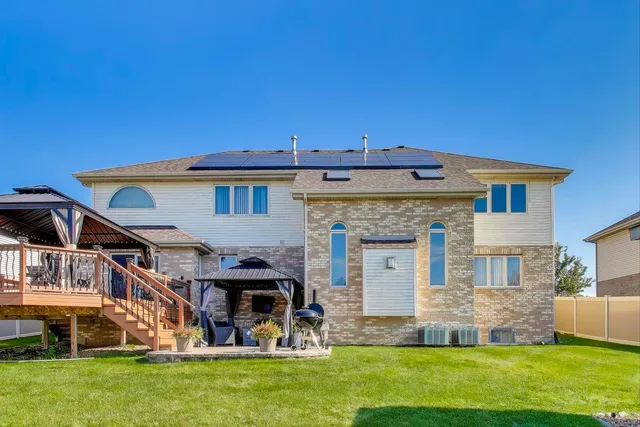 a view of a backyard with plants and a porch