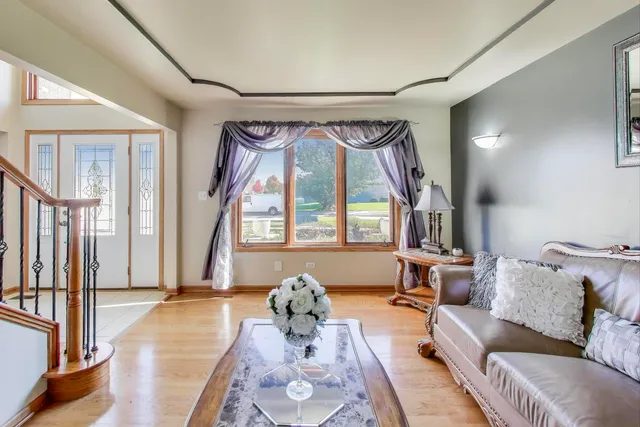 a view of a dining room with furniture a chandelier and wooden floor