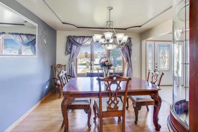 a view of a dining room with furniture and chandelier