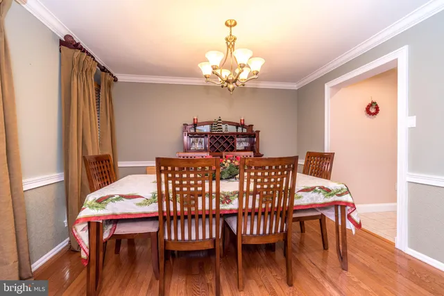 a view of a dining room with furniture wooden floor and chandelier