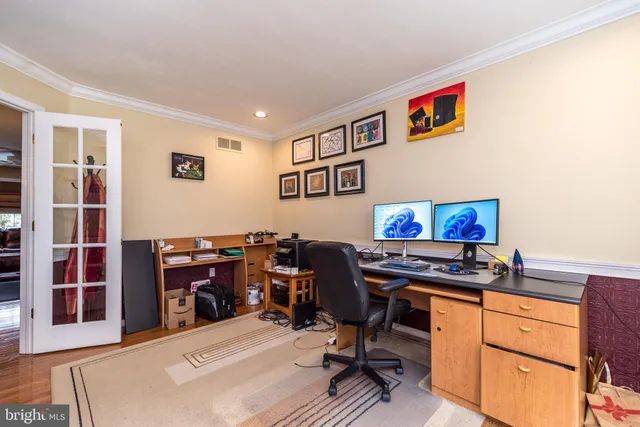 a view of a workspace with furniture and a flat screen tv