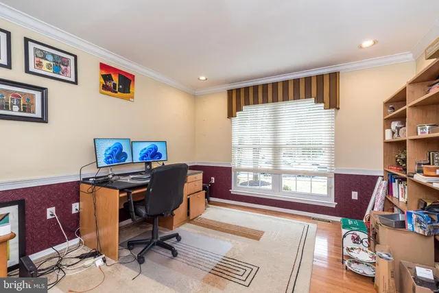 a view of a workspace with furniture and a window