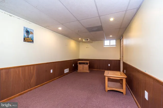 a view of a house with a yard patio and fire pit