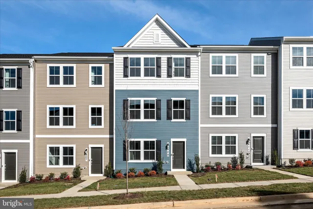a front view of a residential apartment building with a yard