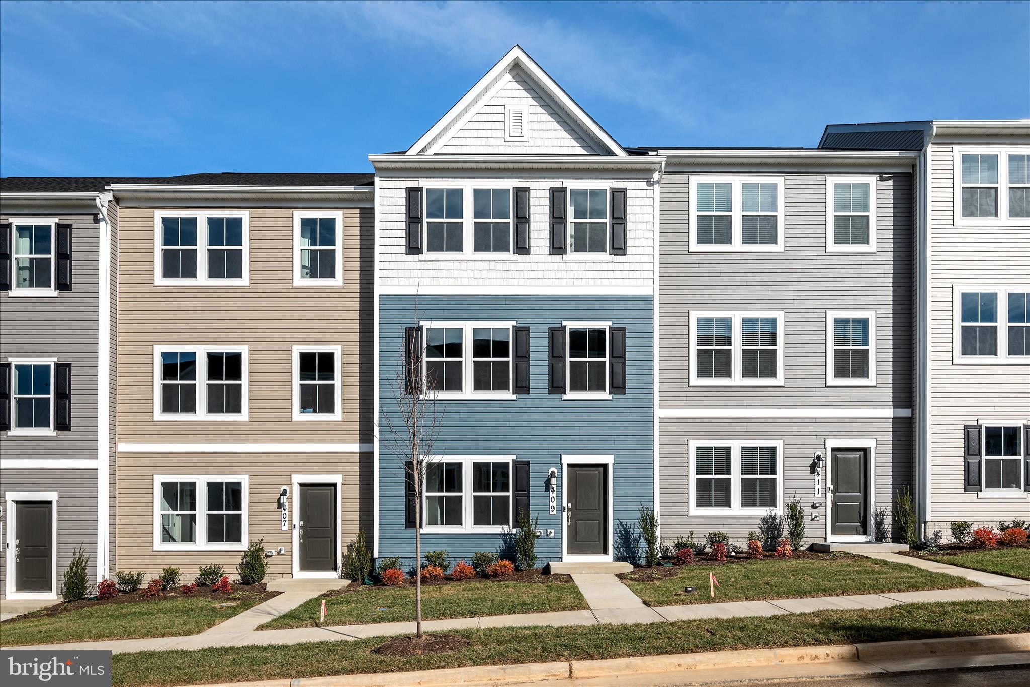 a front view of a residential apartment building with a yard