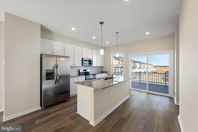 a kitchen with a refrigerator and a sink